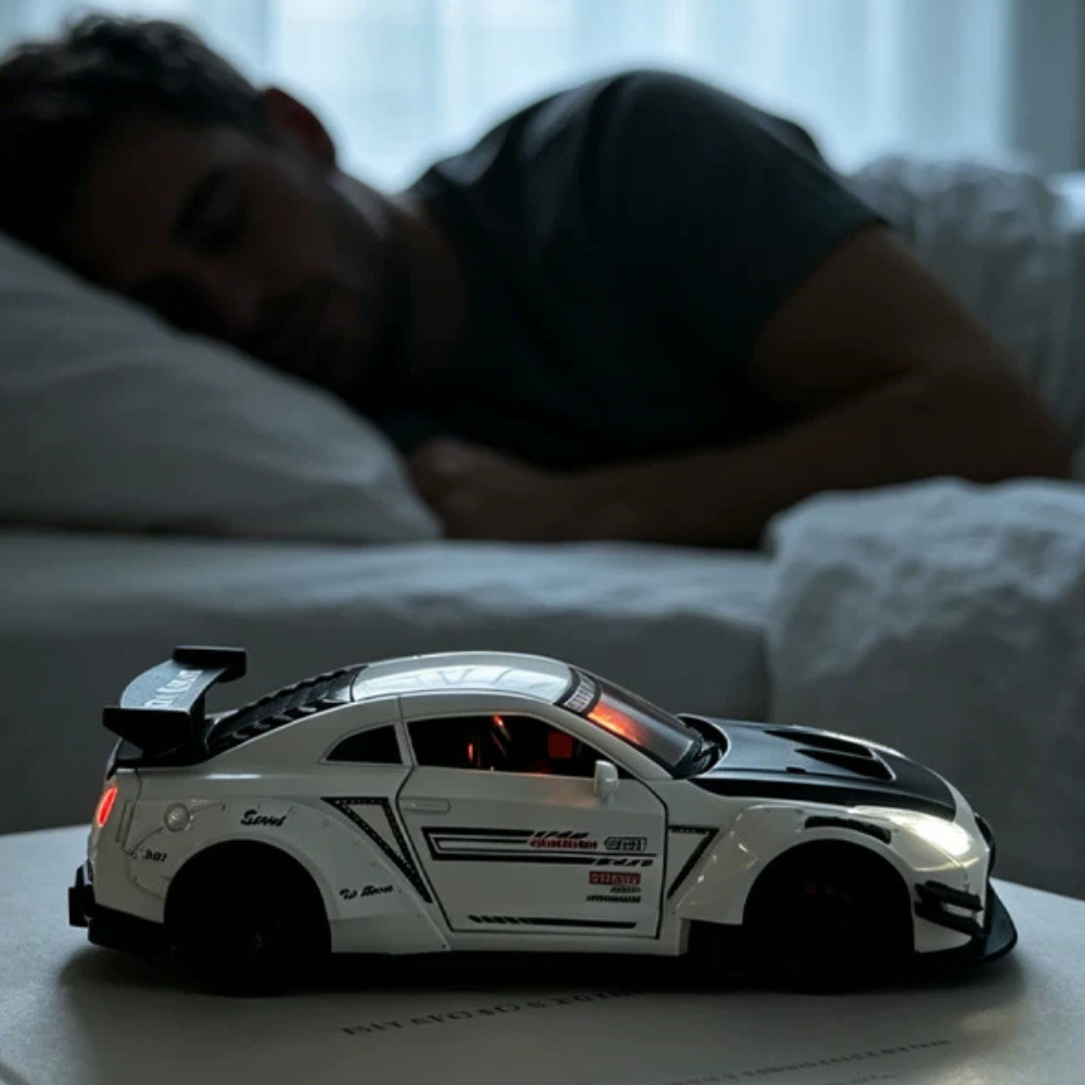 Sports car alarm clock model on bedside table