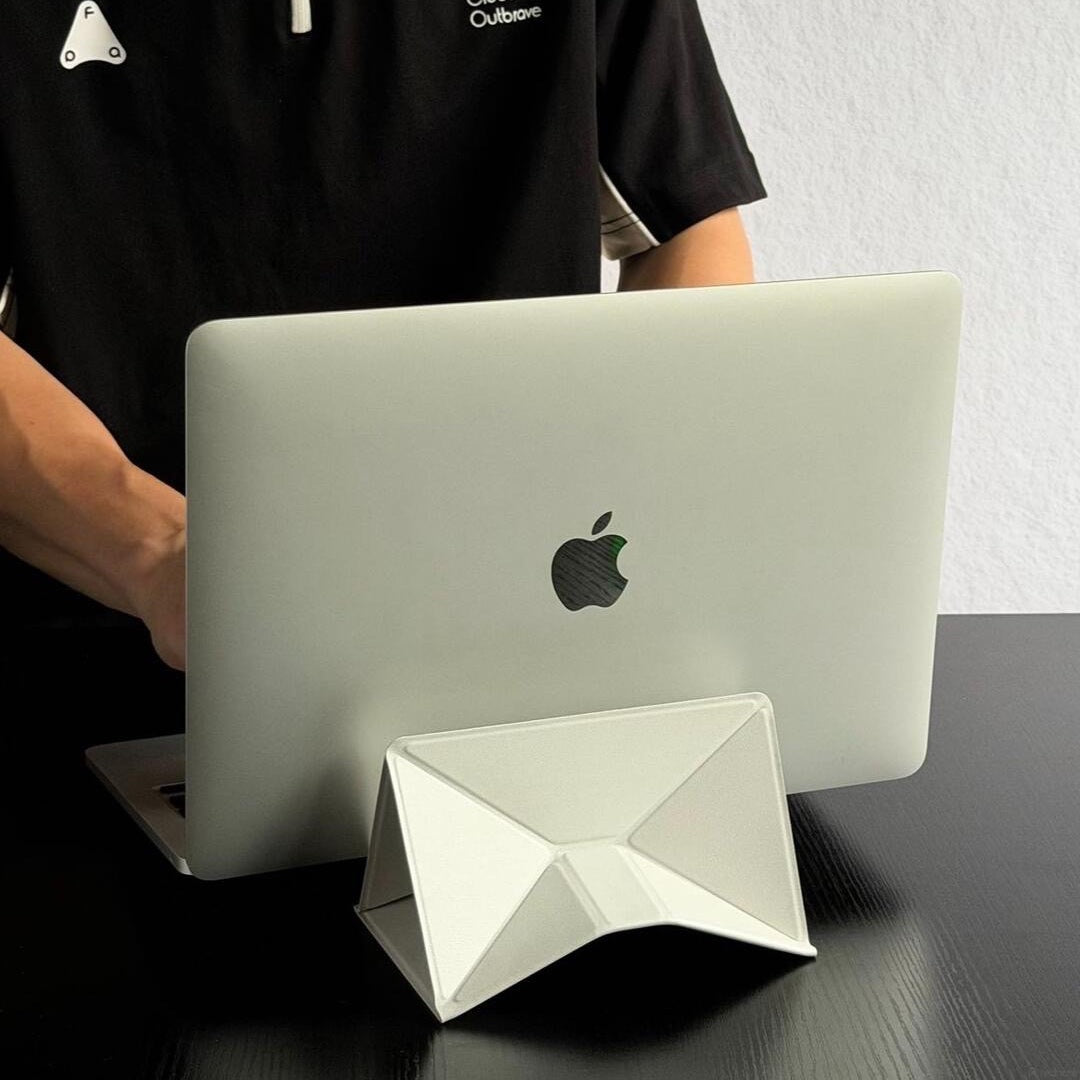 Mist white foldable laptop stand in use