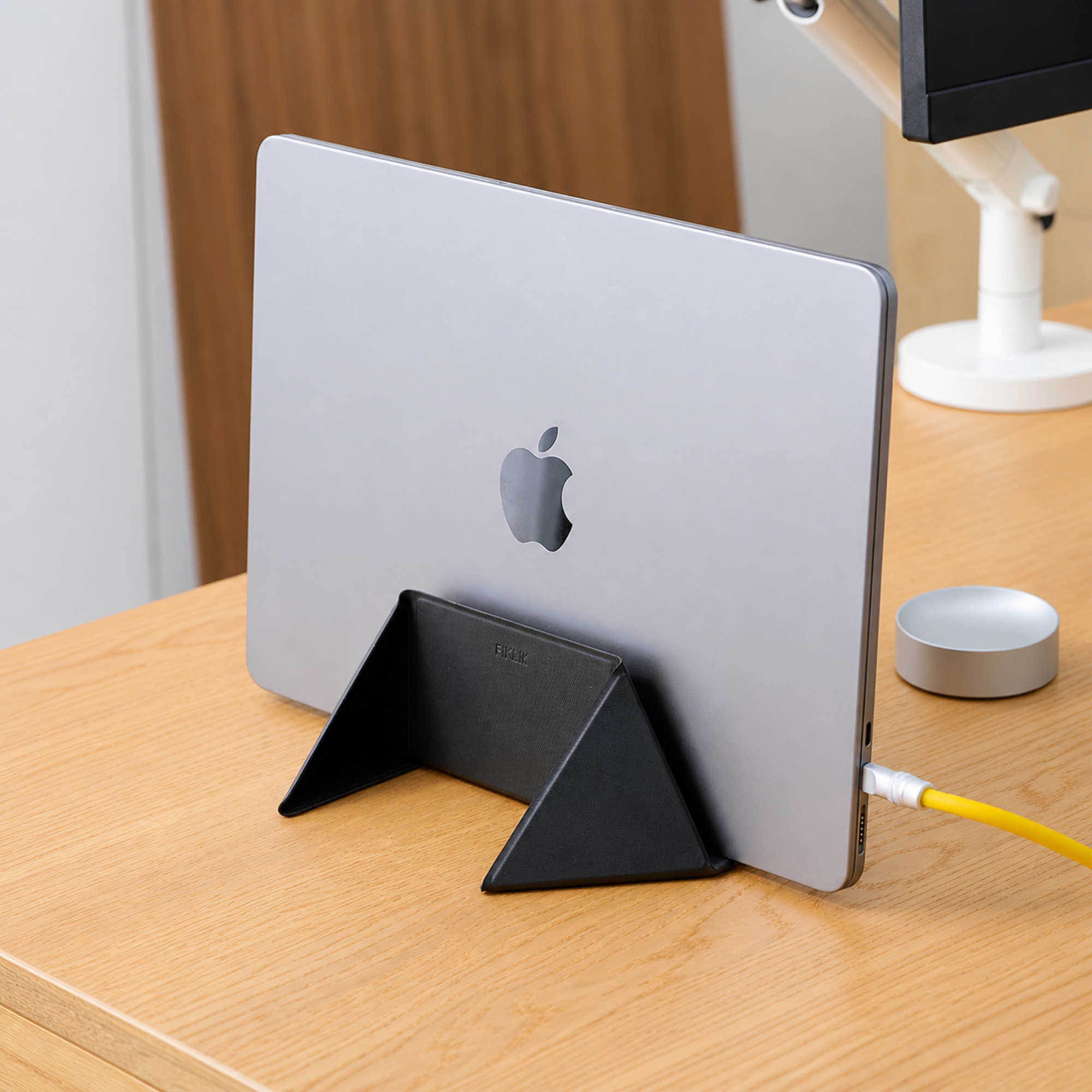 Carbon black laptop stand supporting a laptop